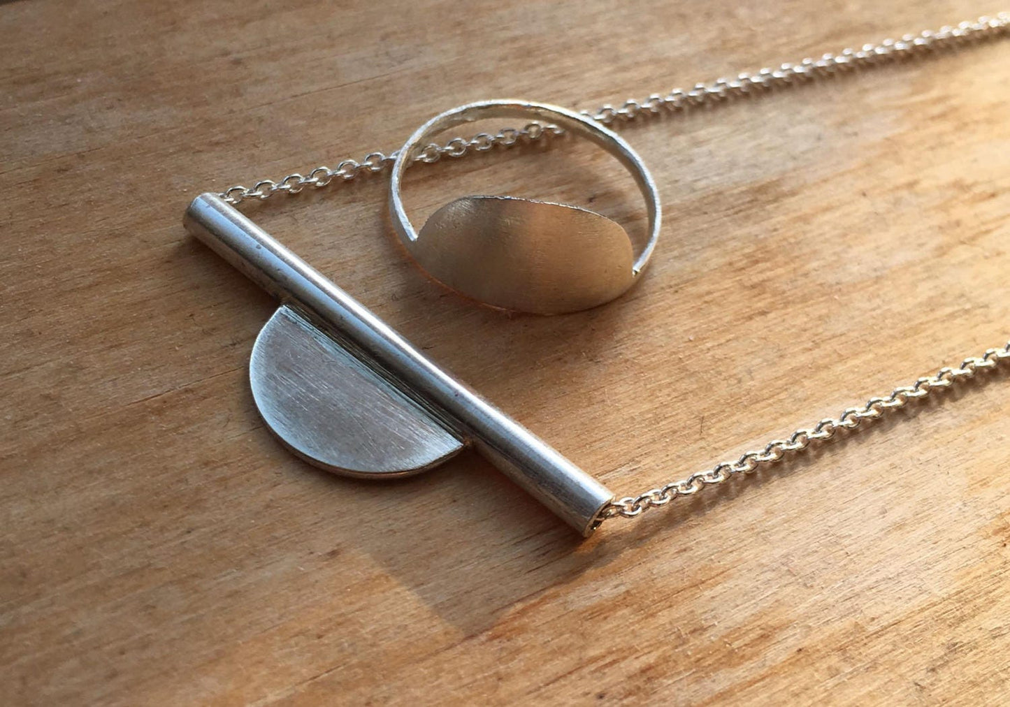 Modern setting sun necklace